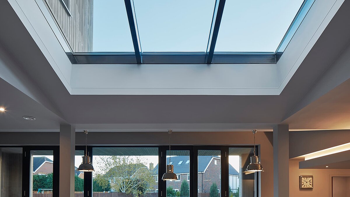 Interior view of a room at Potton Show Homes, England, featuring a LAMILUX PR60 glass roof allowing natural daylight.