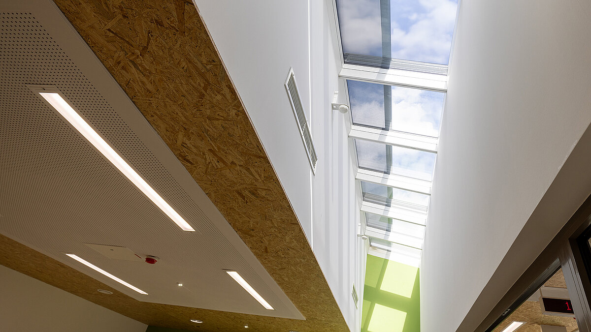 Psychiatry Emmendingen featuring LAMILUX continuous glass rooflight in the corridor for natural daylight supply to the interior space