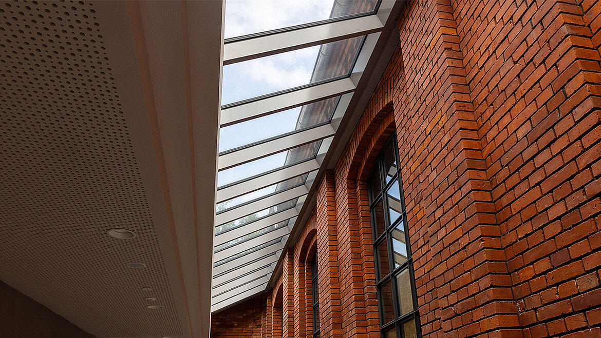 LAMILUX Glass Roof Fire Resistance with fire-rated glazing along historic brick façade