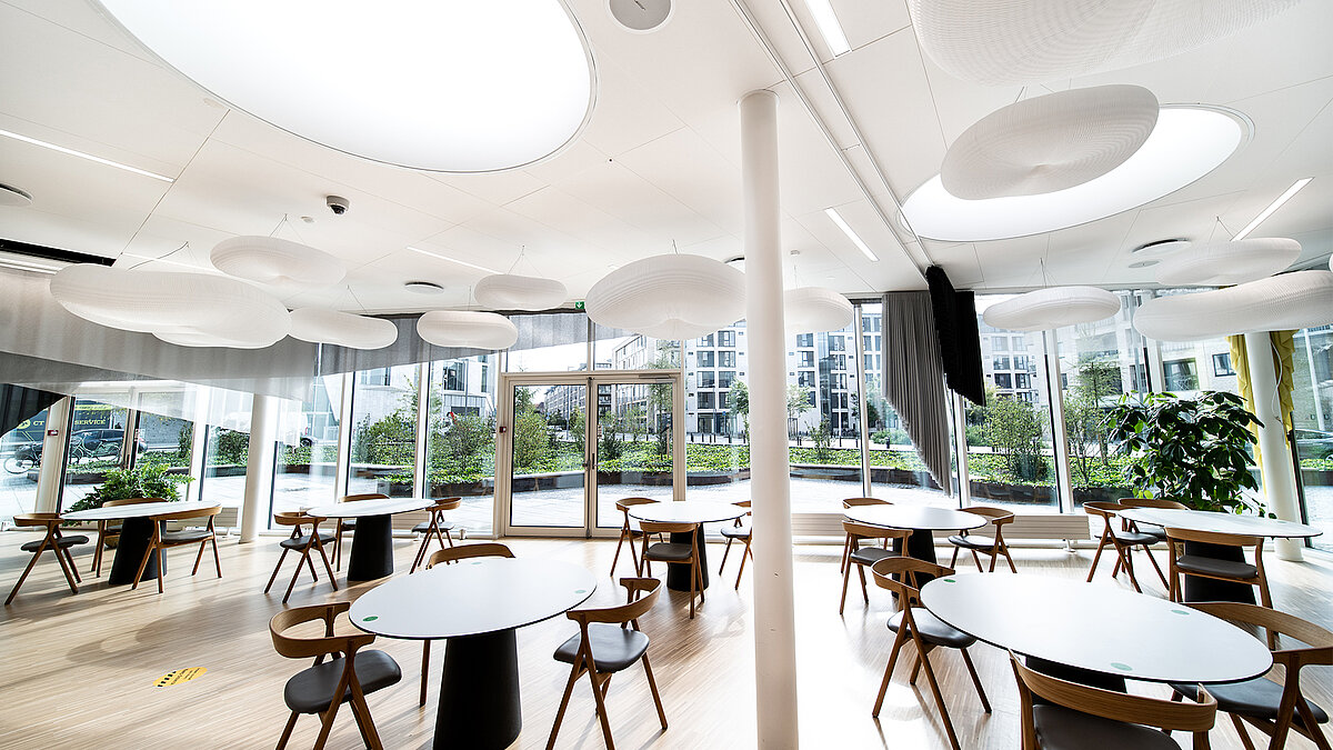 EY office building with modern lounge area, circular skylights and large glass facade