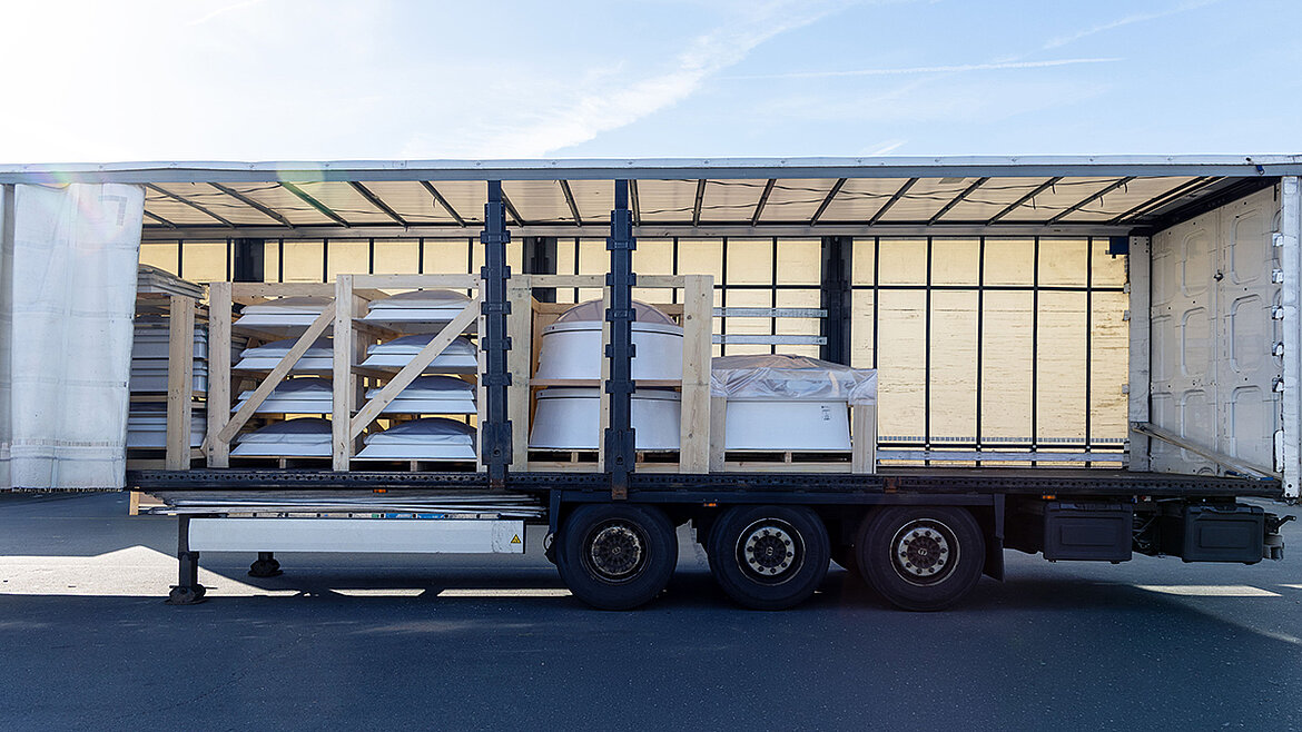 An open truck loaded with packaged LAMILUX skylights