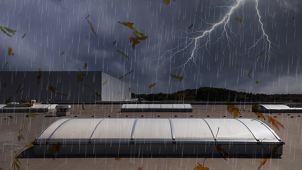 Flat roof with skylights during a thunderstorm with rain and lightning