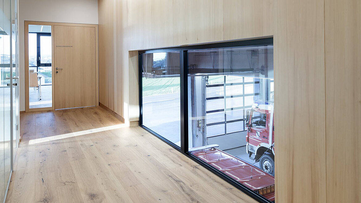 Window from the nursery into the fire station vehicle hall