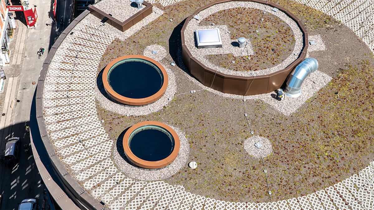 flat roof with two circular skylights and rooftop technical structures top view