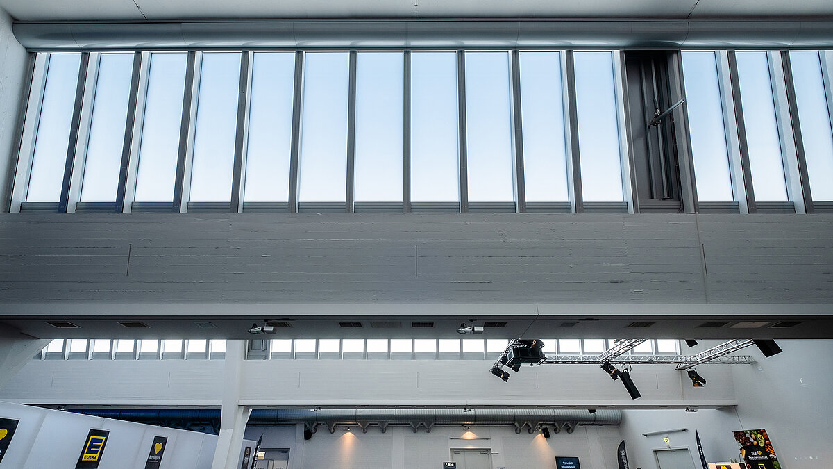 Interior view of the Vogel Convention Center in Würzburg with modern glass roof elements and bright lighting.