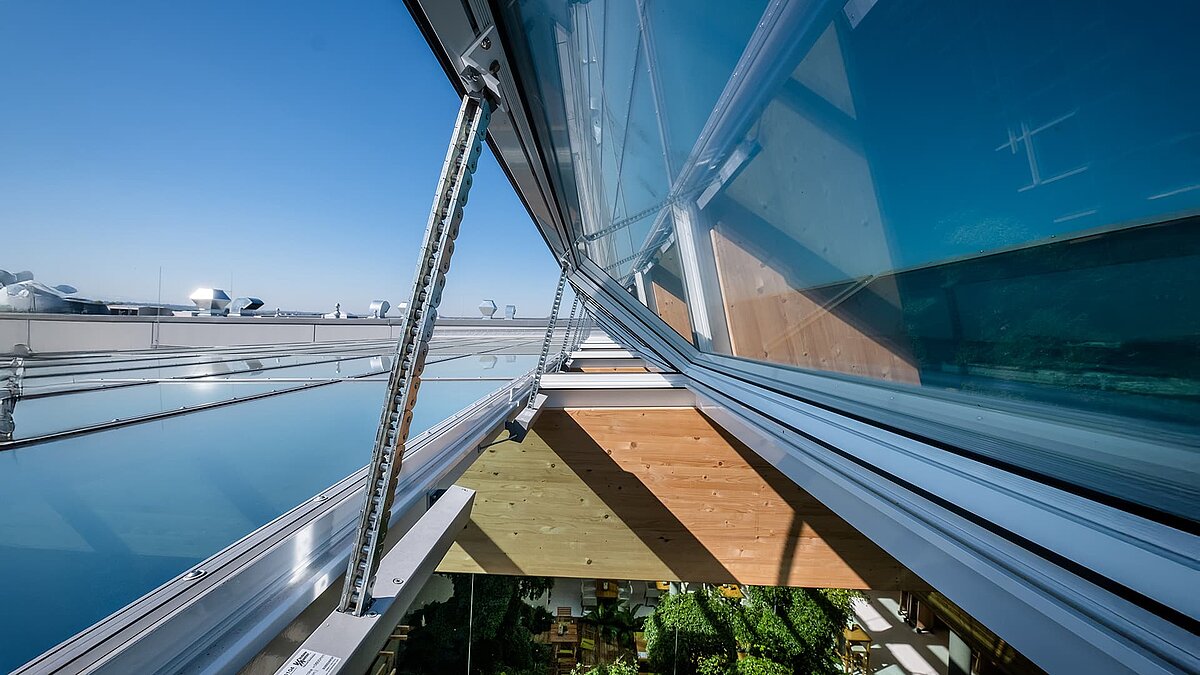 Close-up of the modern opening system of the glass roof structure at the Byodo organic food store in Mühldorf, ensuring optimal ventilation.