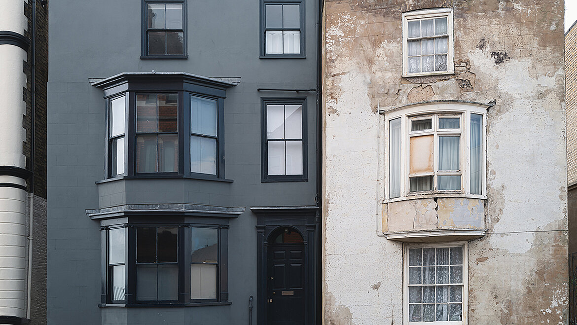 An old and a new building represent the meaning of renovation.