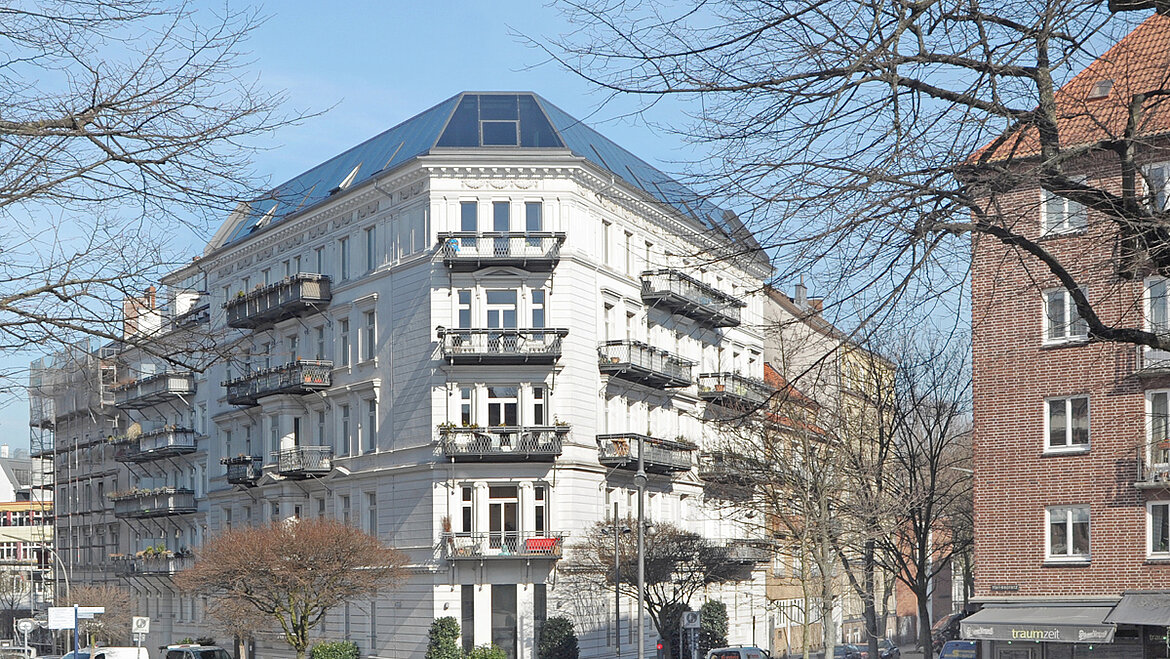 A multi-story residential building with a roof extension.