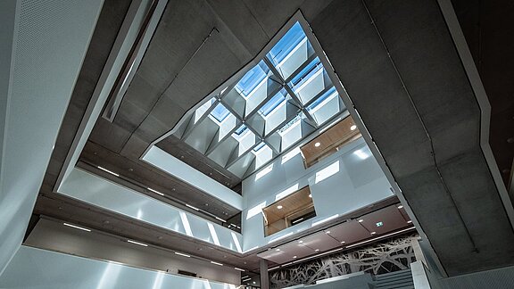 Interior view of a modern glass roof that lets daylight into a multi-storey building
