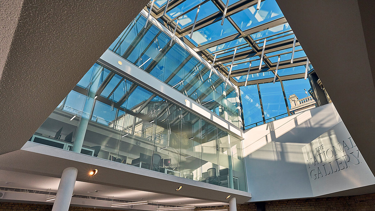 Modern glass roof with steel beams and natural light in interior space