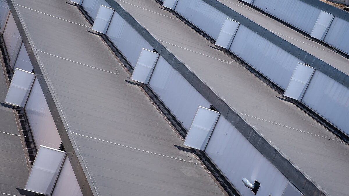 Roof view of the old post station in Leipzig with modernized skylights and energy-efficient renovation.