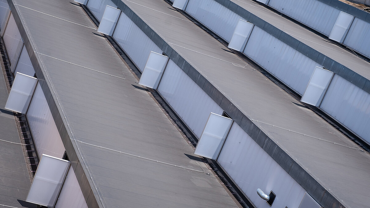 Roof view of the old post station in Leipzig with modernized skylights and energy-efficient renovation.