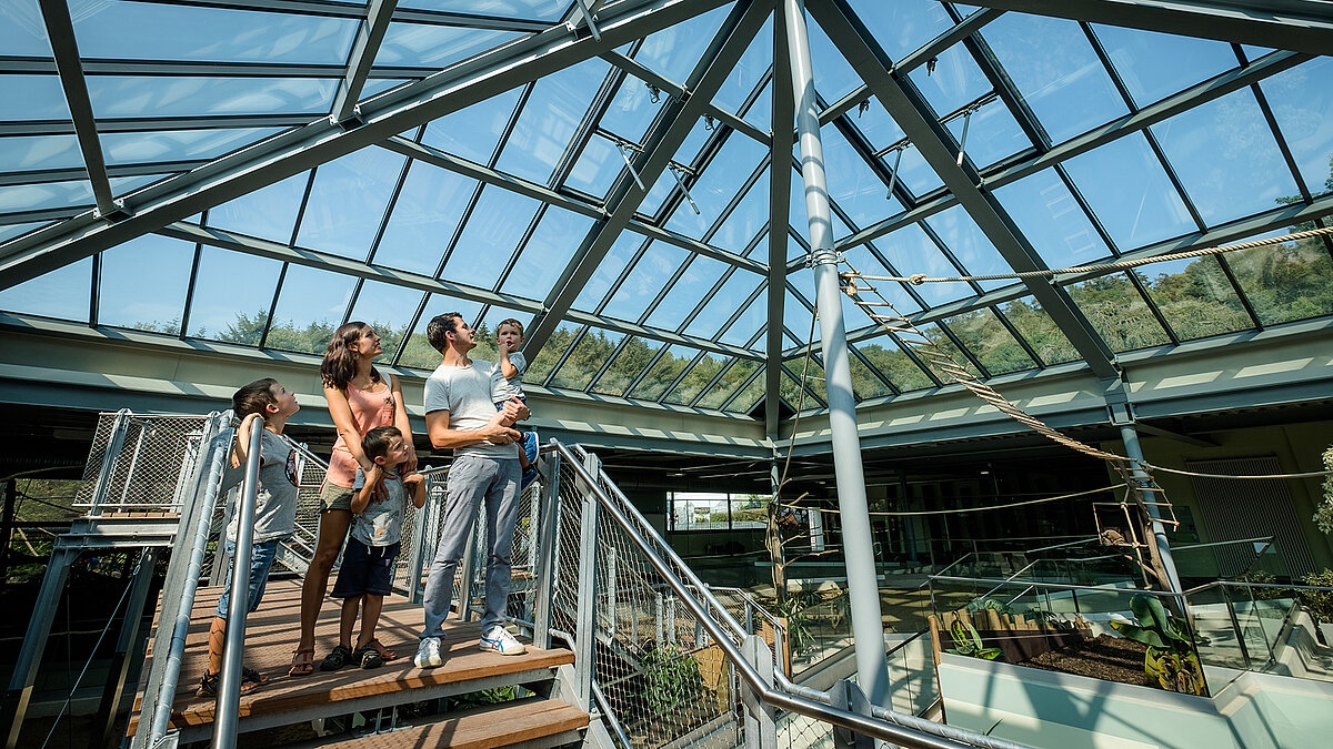 Visitors at Zoo Neuwied under the PR60 glass structure, illuminating the interior space.