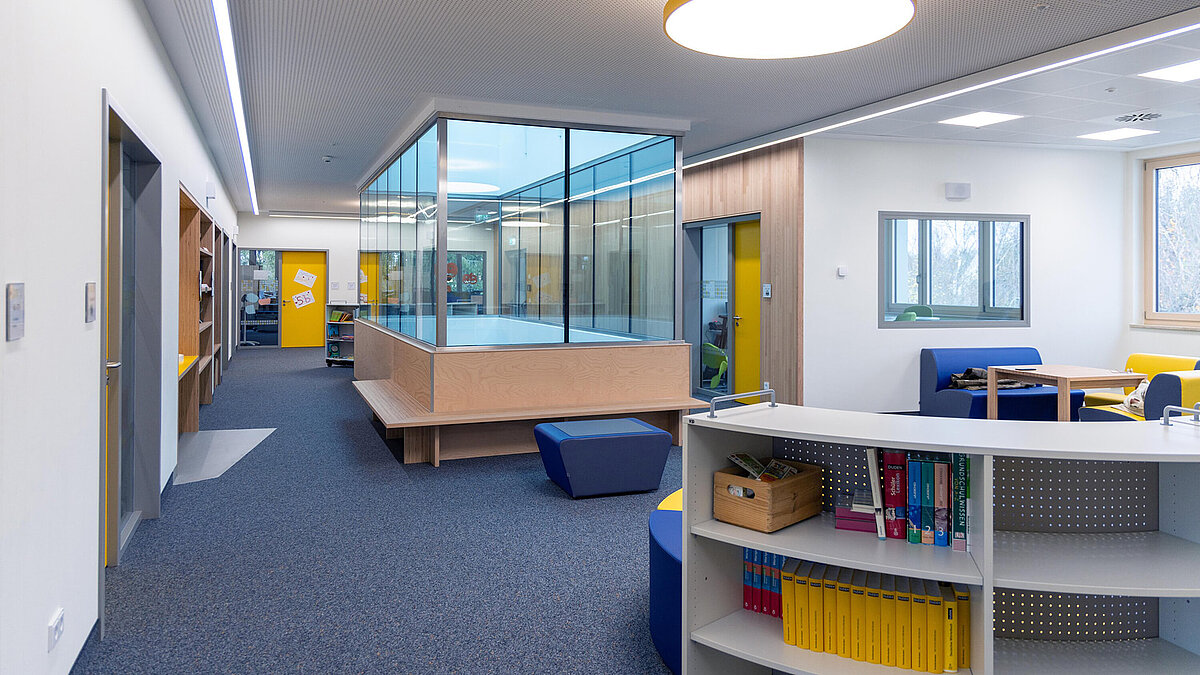LAMILUX glass roof PR60 at Burgebrach school center with glass room and modern interior design.