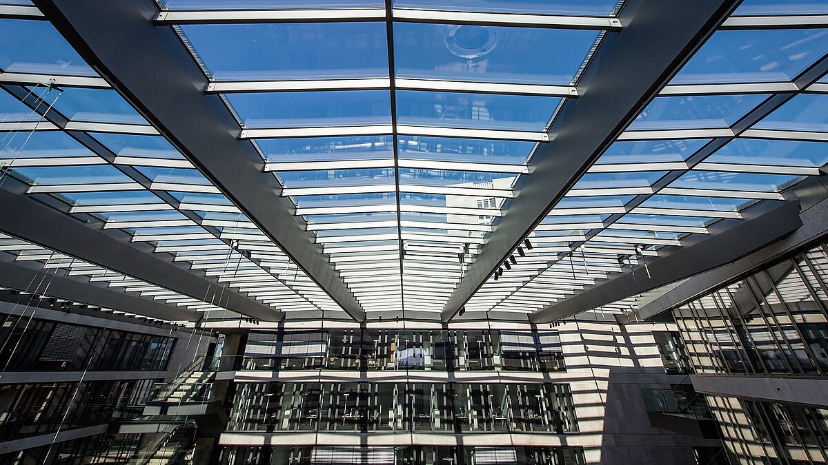 Glass roof of the FGS Campus with modern design and clear sky reflections.