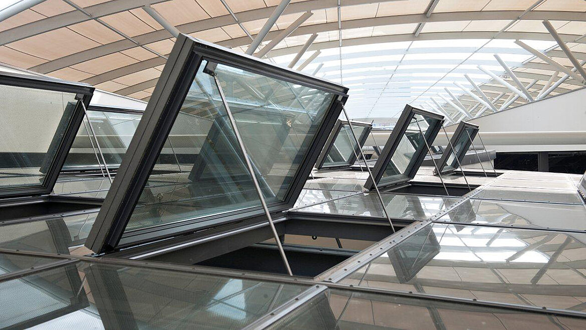 Opened smoke and heat extraction flaps in the glass roof Glass roof of the Rhine Gallery Ludwigshafen with open NSHEVs | insights by LAMILUX