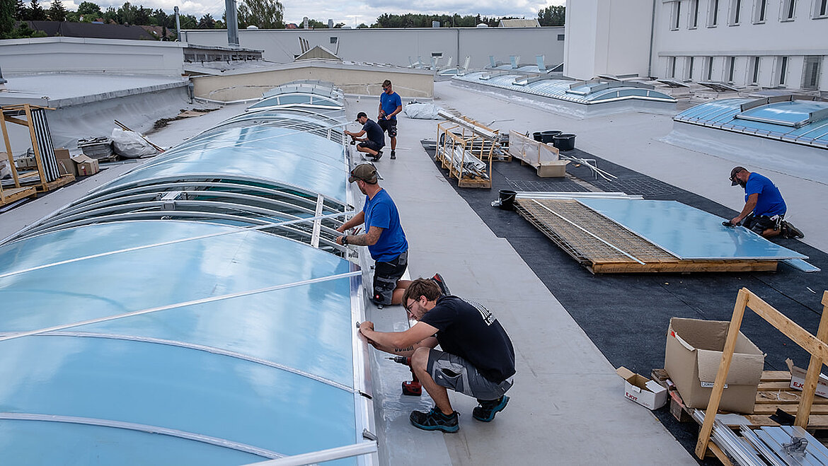 Workers renovationg a flat roof Workers renovationg a flat roof