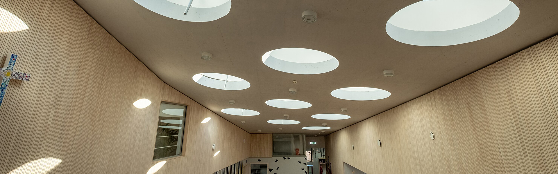 Interior space with multiple round skylights providing even natural daylight illumination