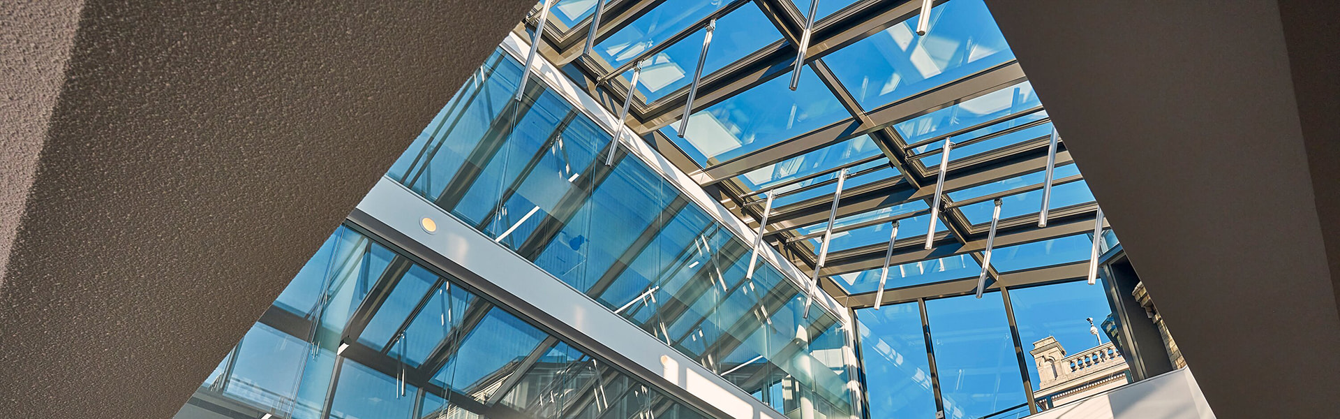 Interior view of a modern atrium with glass roof and natural light