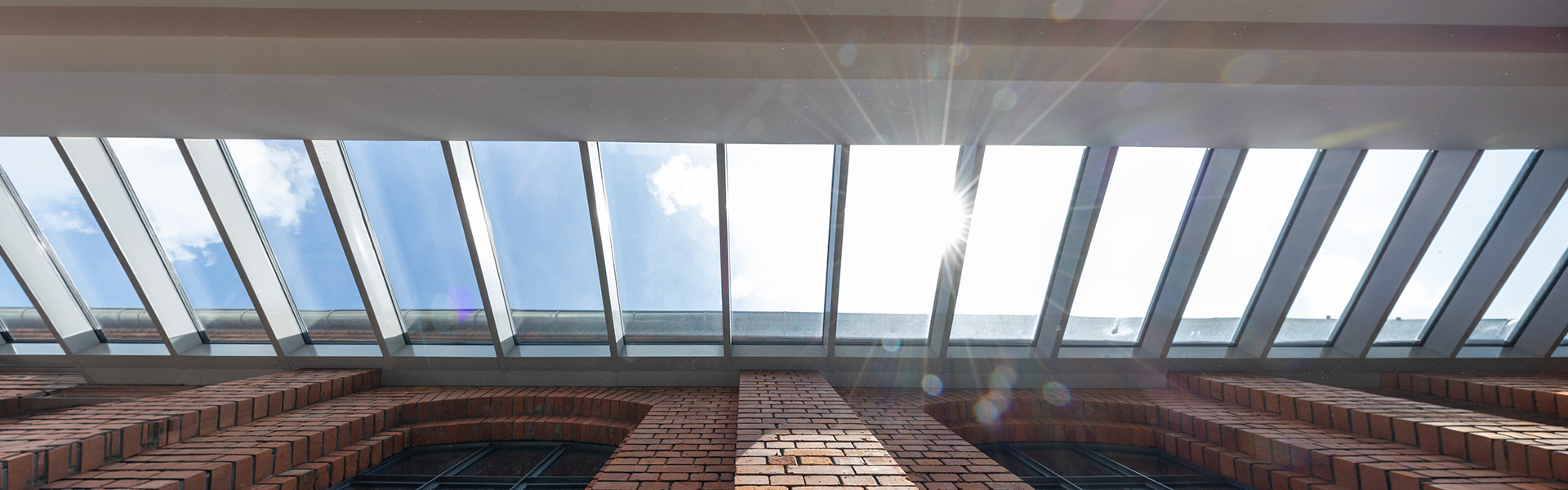 LAMILUX Glass Roof with large-scale glazing above historic courtyard