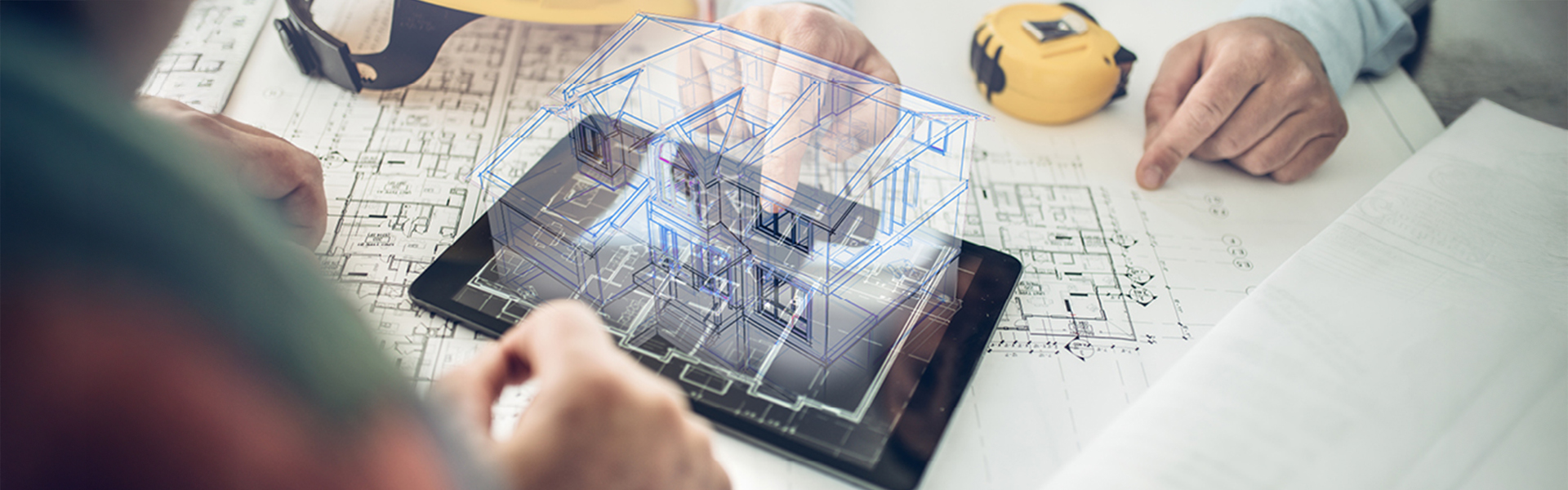 Architects look at a digital construction plan on a tablet.